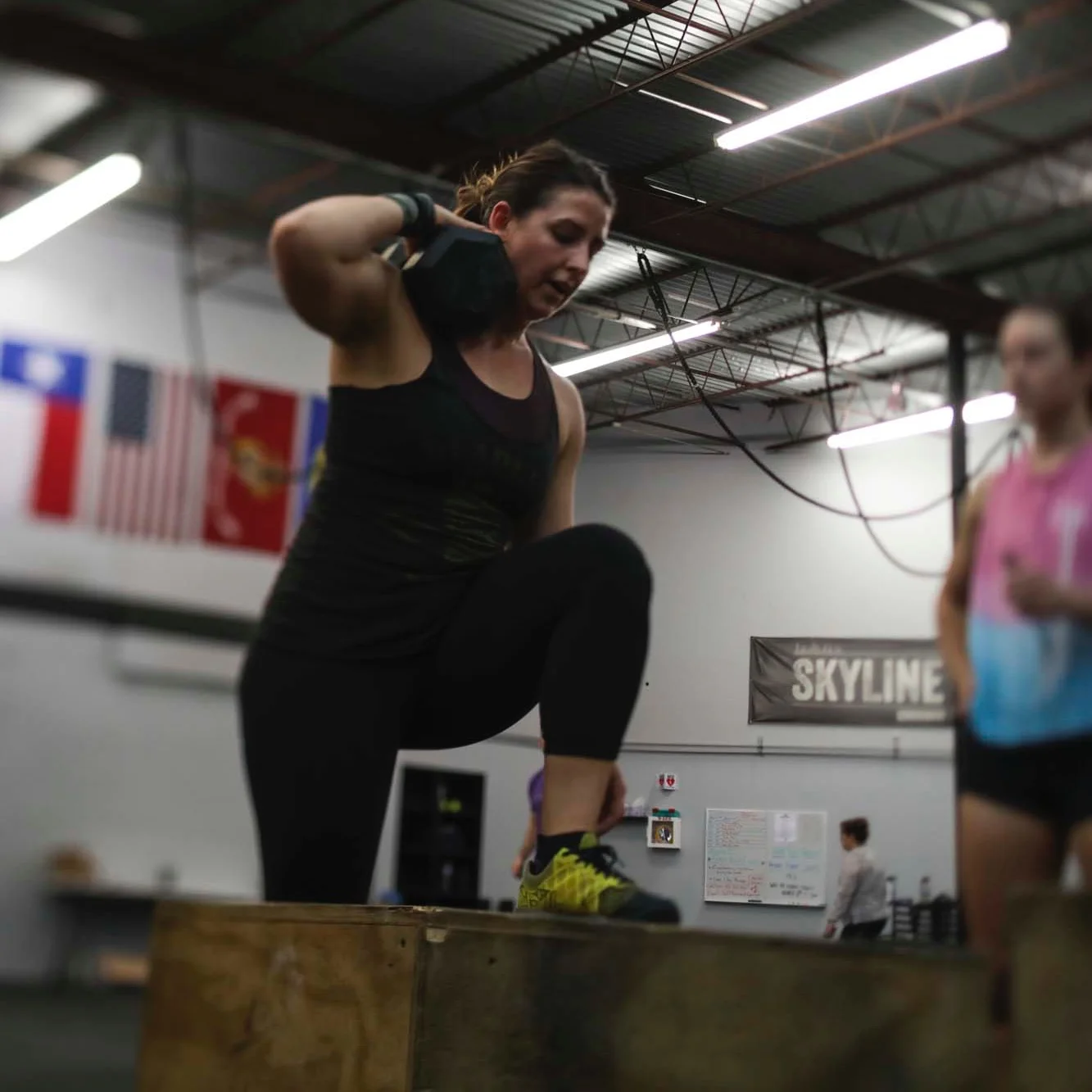 Ciji a recent transplant from Los Angeles performing weight step-ups during 19.3 CrossFit Open.