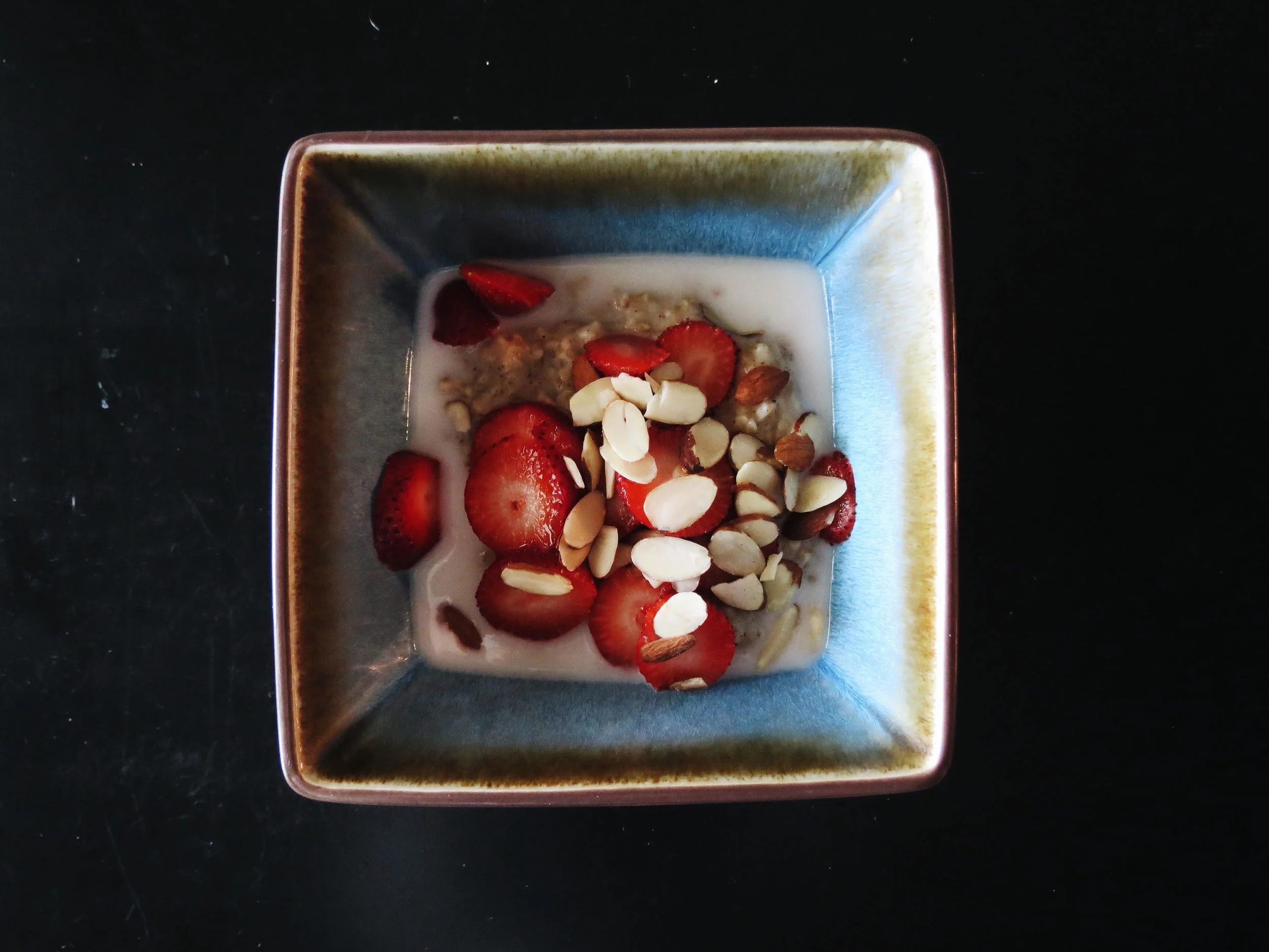 gluten-free, steel cut oats w/ strawberries, almonds + almond/coconut milk