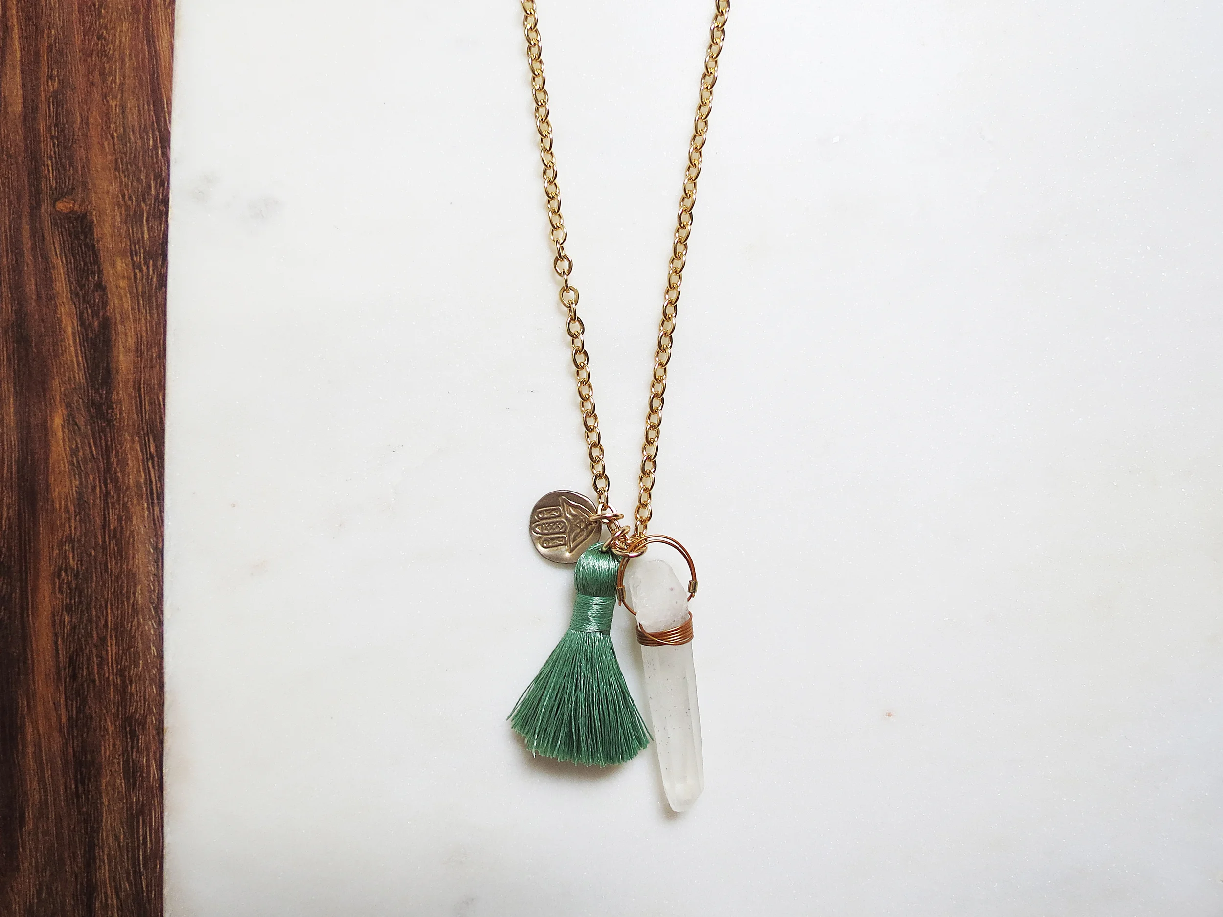 Talisman minimal modern handmade jewelry gold brass hamsa, raw white quartz crystal nylon silk tassel long statement necklace detail turquoise