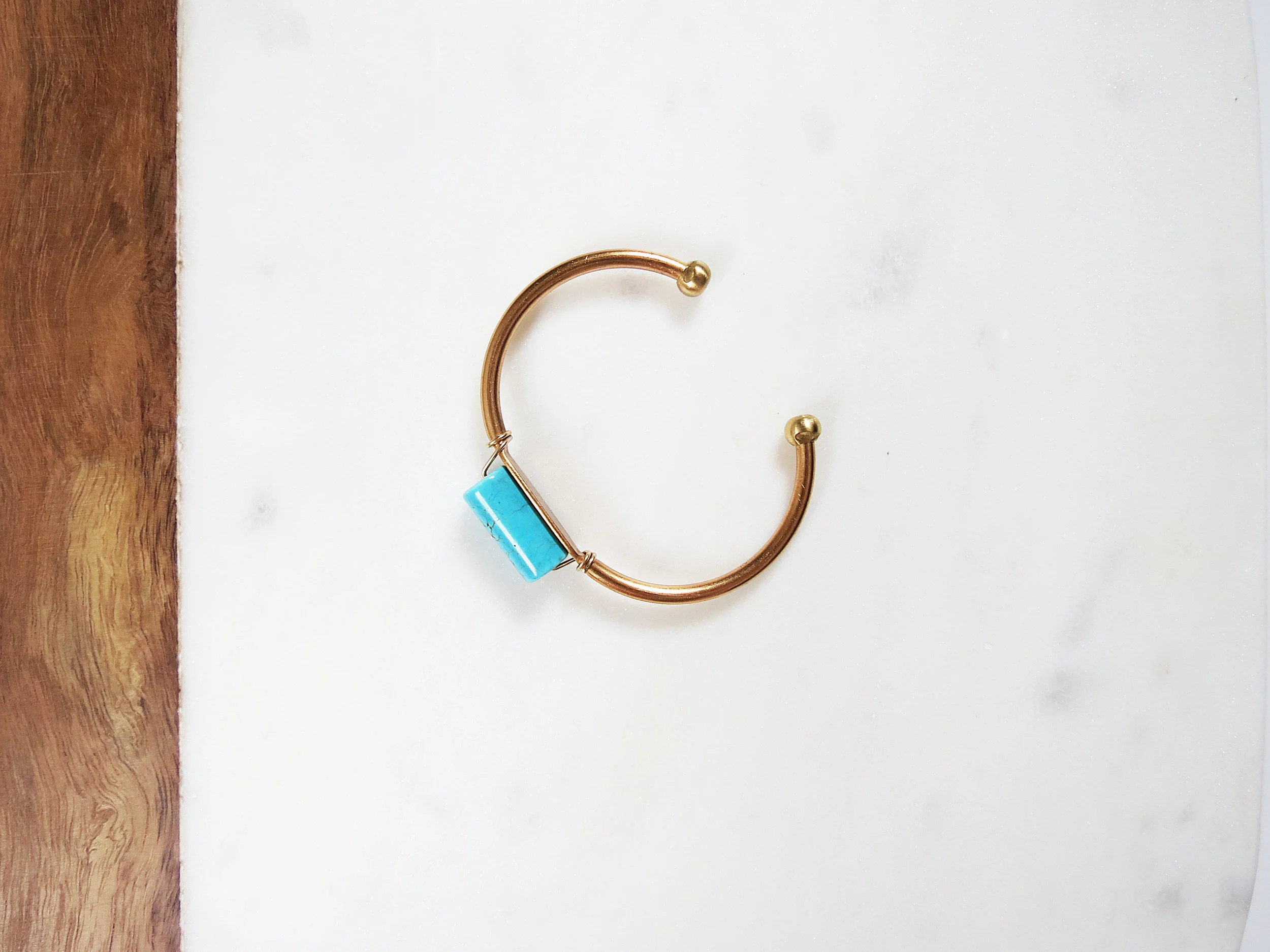 Turq Roll minimal modern handmade jewelry gold raw brass, gold-filled wire + turquoise howlite cuff bracelet overhead view