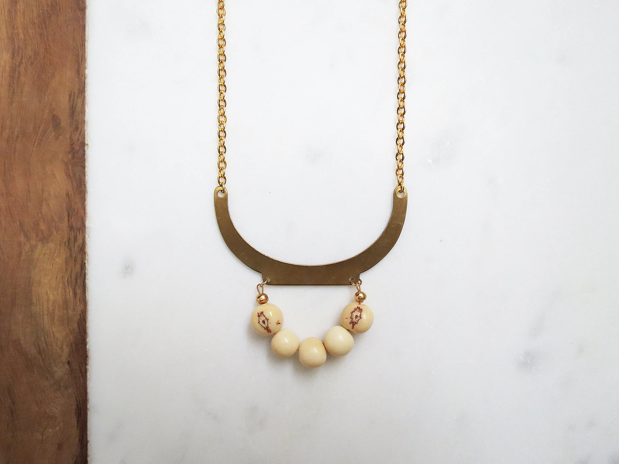 Olly minimal modern handmade jewelry gold raw brass + white acai beads short statement necklace detail