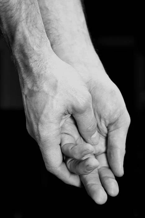 close-up image of two hands holding each other