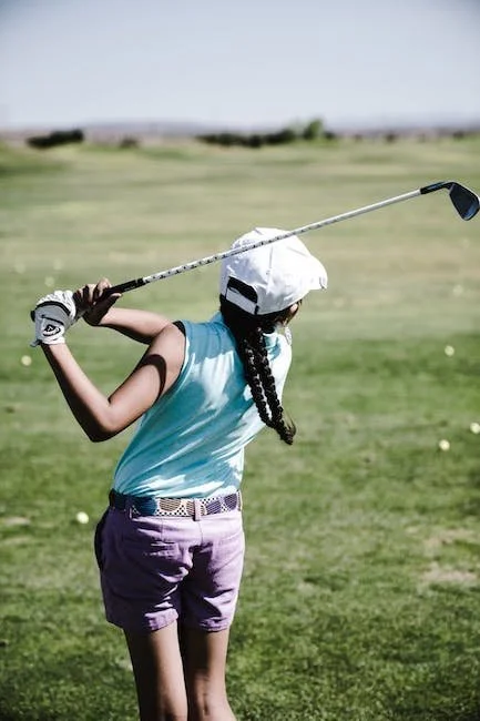 woman swinging golf club in open field