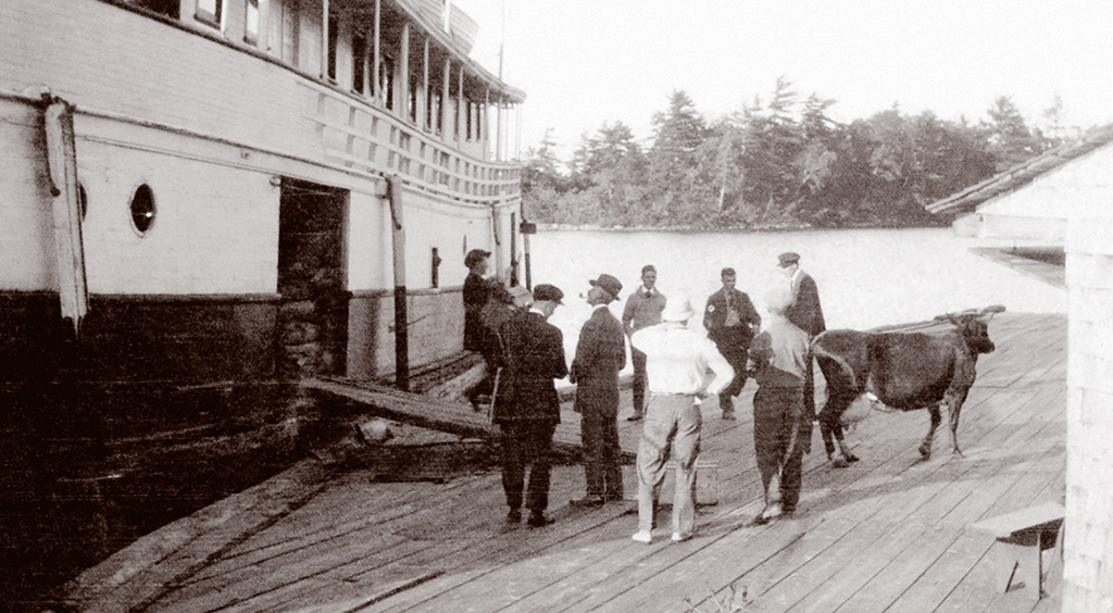 Hamilton Davis (above, left, with pipe) oversees the arrival of the hotel cow. 