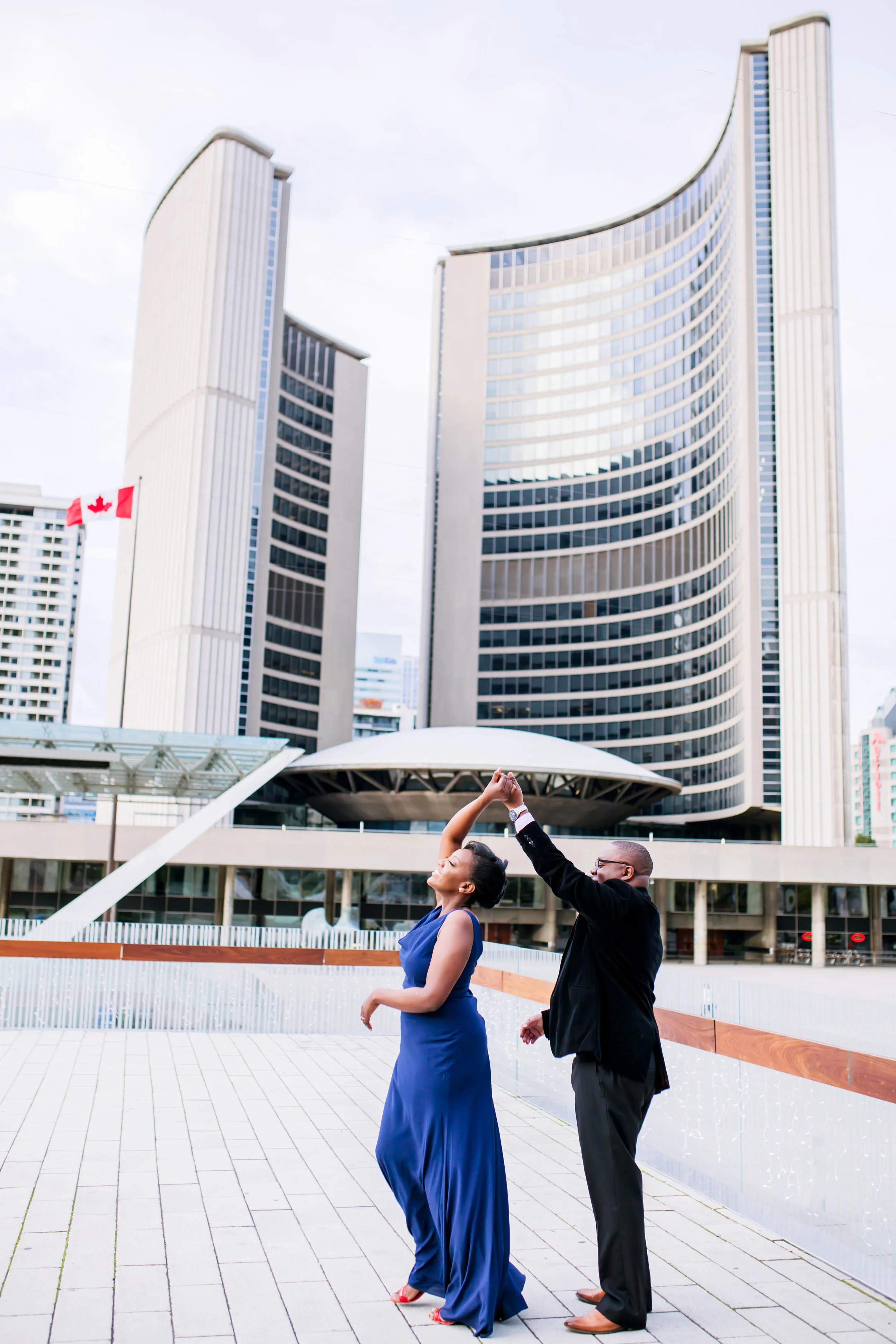 African Canadian Kenyan Engagement Shoot Nathan Phillips square Toronto sign Old City Hall Engagement Photography Toronto Kenyan Kenya Osgoode Hall Toronto Downtown location Photographer Elegant photo ideas Ontario Canada African Black Couple Best Photographer Karimah Gheddai Photography Futuristic Architecture