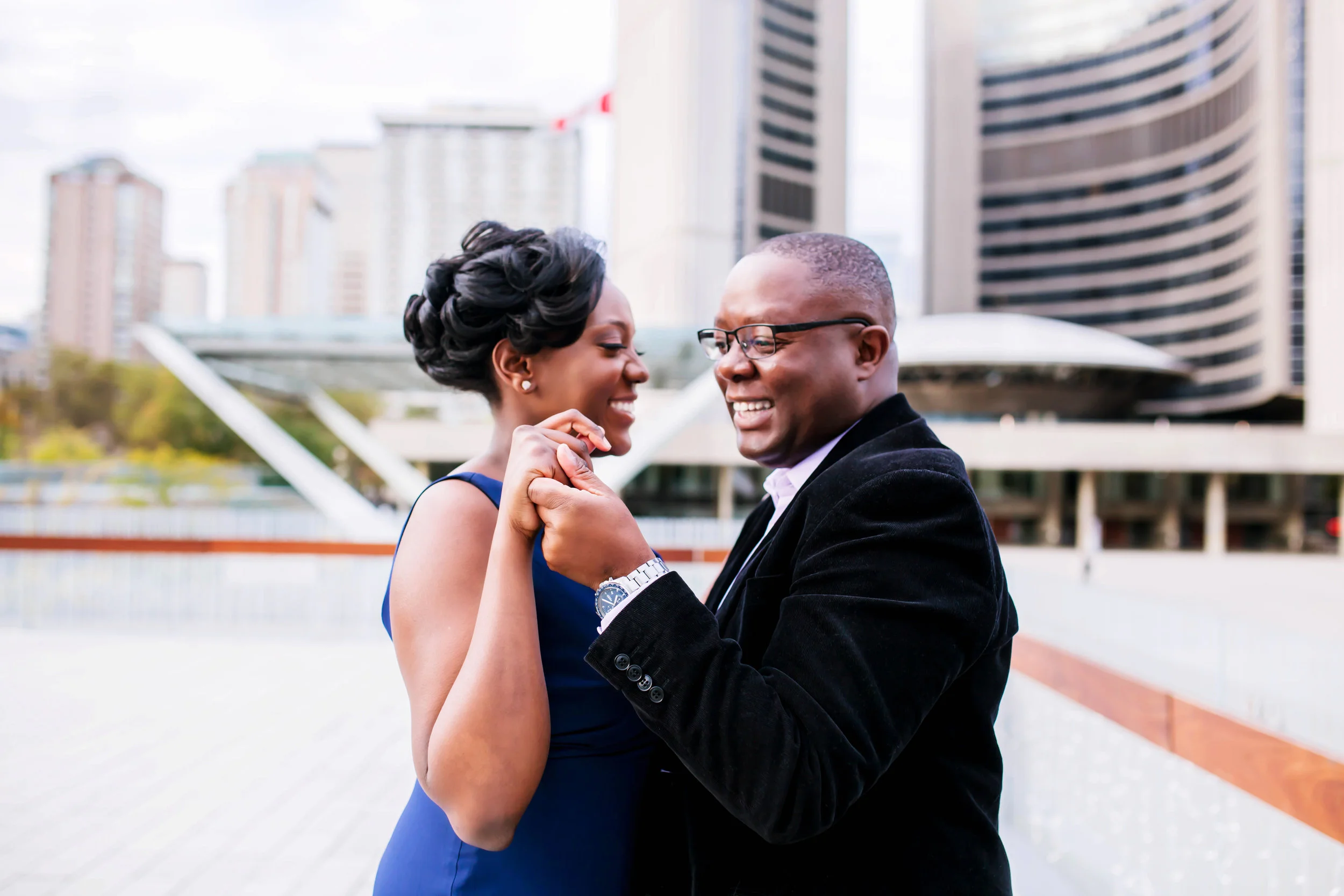African Canadian Kenyan Engagement Shoot Nathan Phillips square Toronto sign Old City Hall Engagement Photography Toronto Kenyan Kenya Osgoode Hall Toronto Downtown location Photographer Elegant photo ideas Ontario Canada African Black Couple Best Photographer Karimah Gheddai Photography Dancing