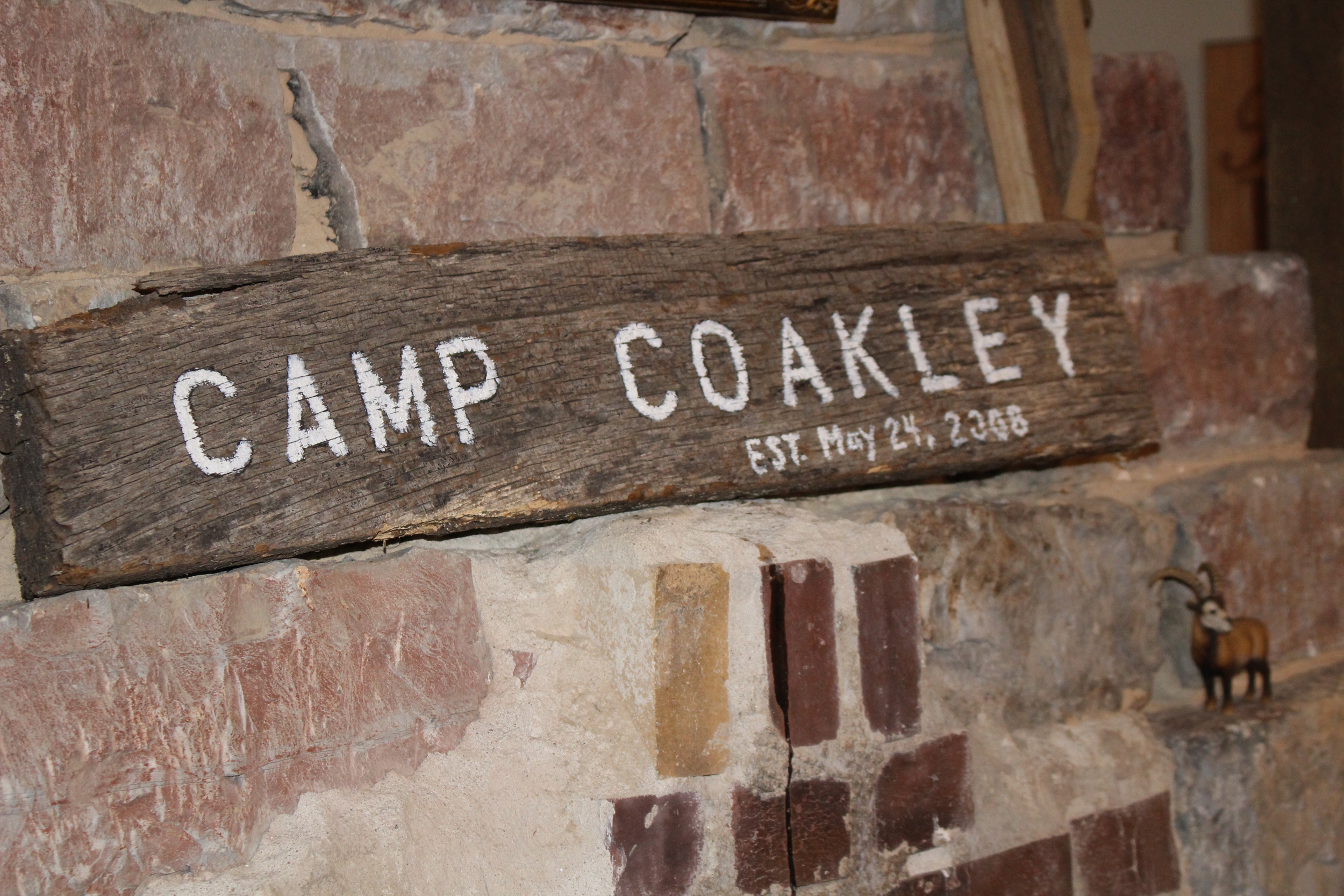 Camp Coakley sign (wedding) displayed over fireplace