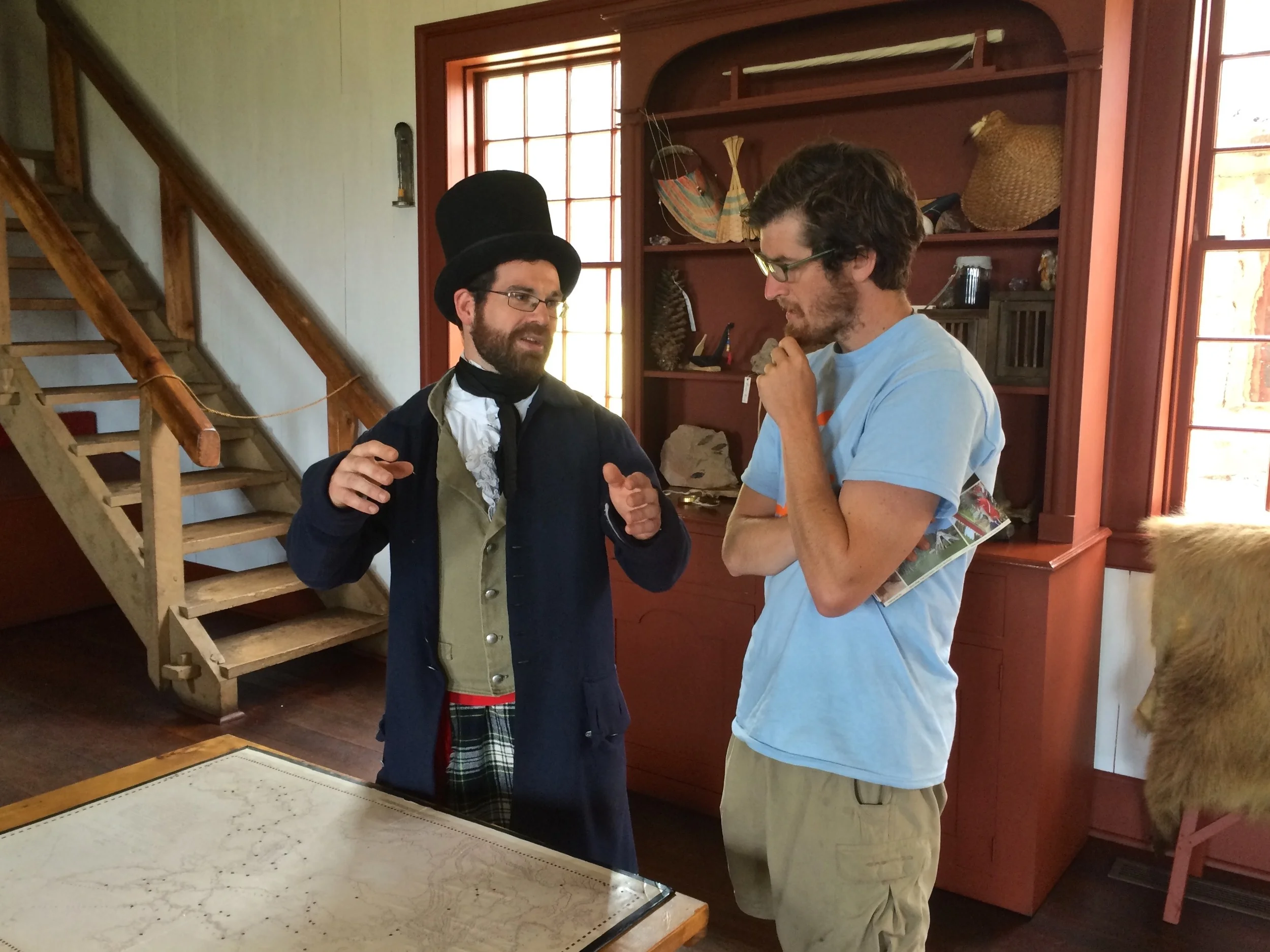 Time traveler wearing a beaver hat while explaining to Darius how important beaver hats were in the 1800s.