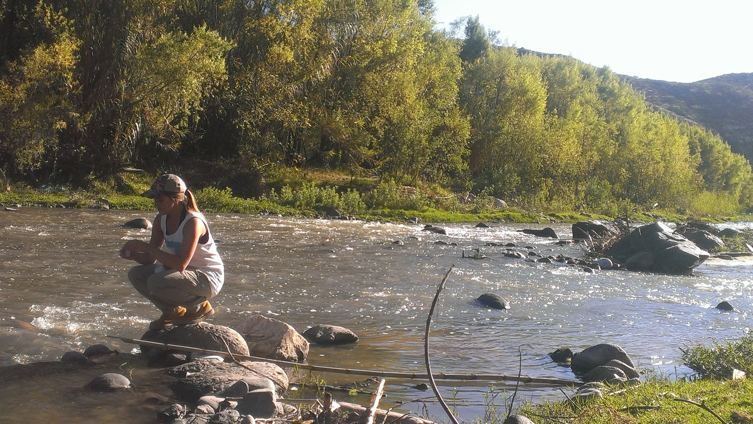 Theresa Miller (VU class of 2018) sampling stream water in Peru.