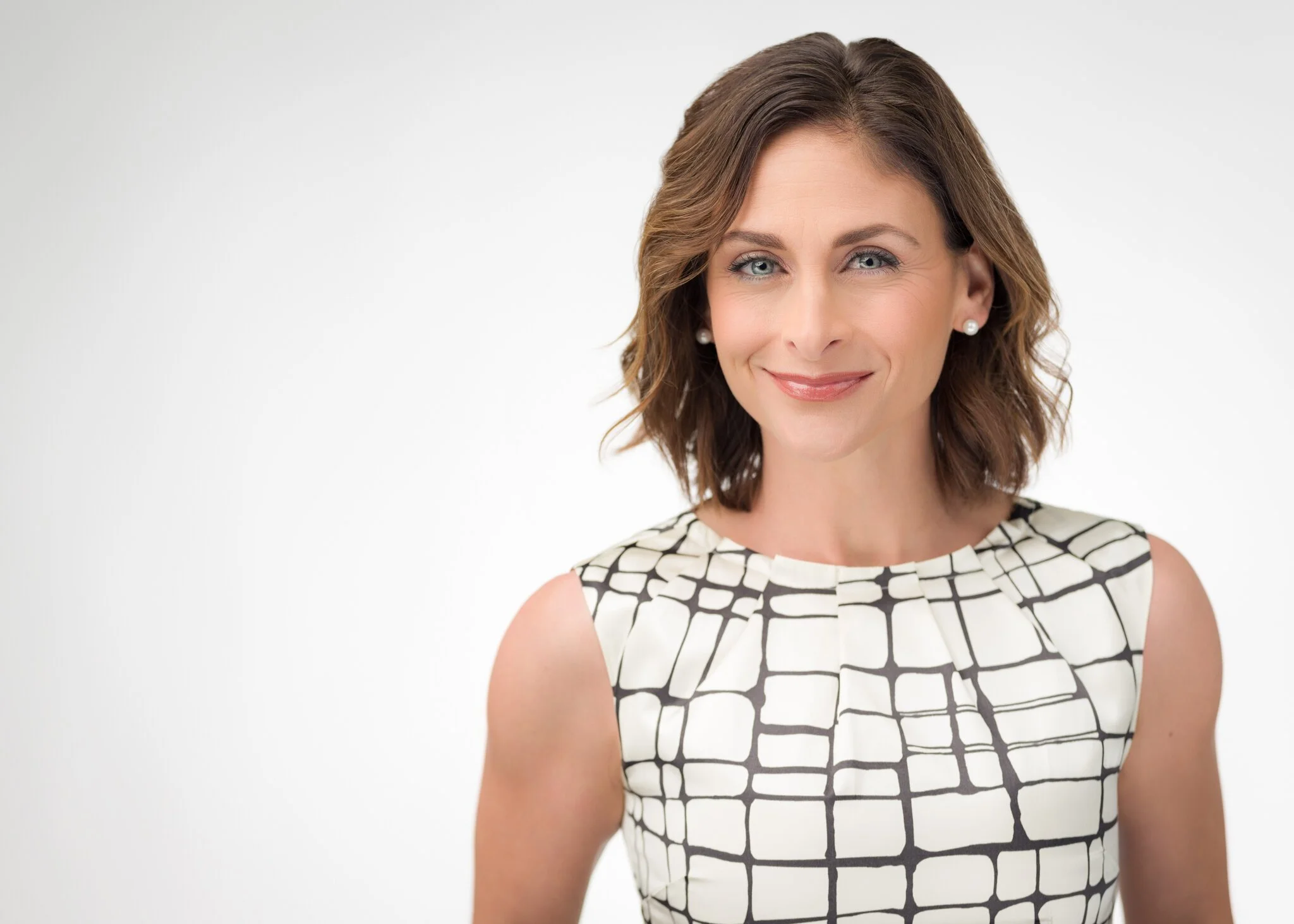 Professional headshot of a woman on a white background.