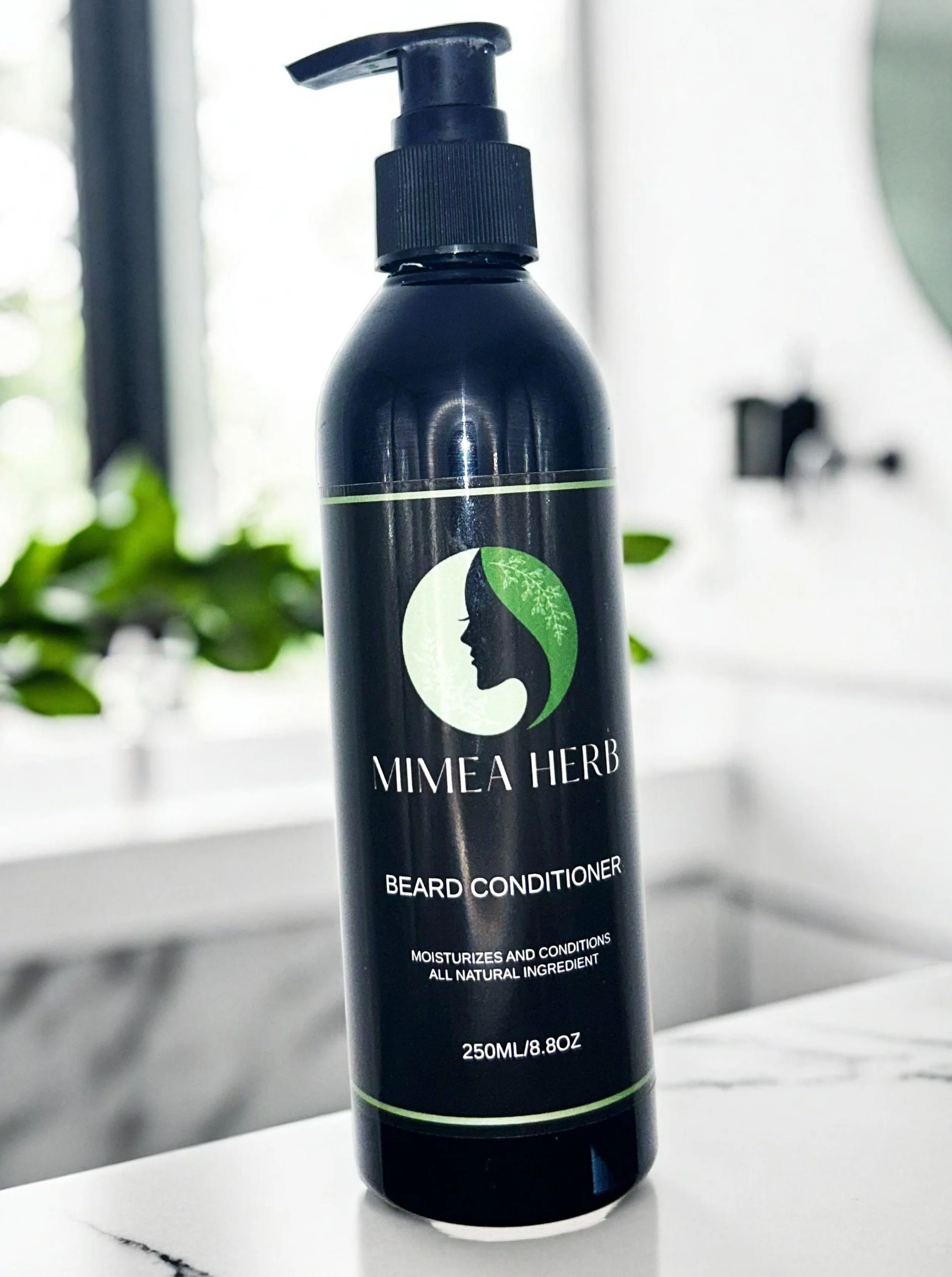 A black bottle with a pump dispenser labeled Mimea Herb Beard Conditioner, stating it moisturizes and conditions with all natural ingredients, containing 250ml or 8.8oz.