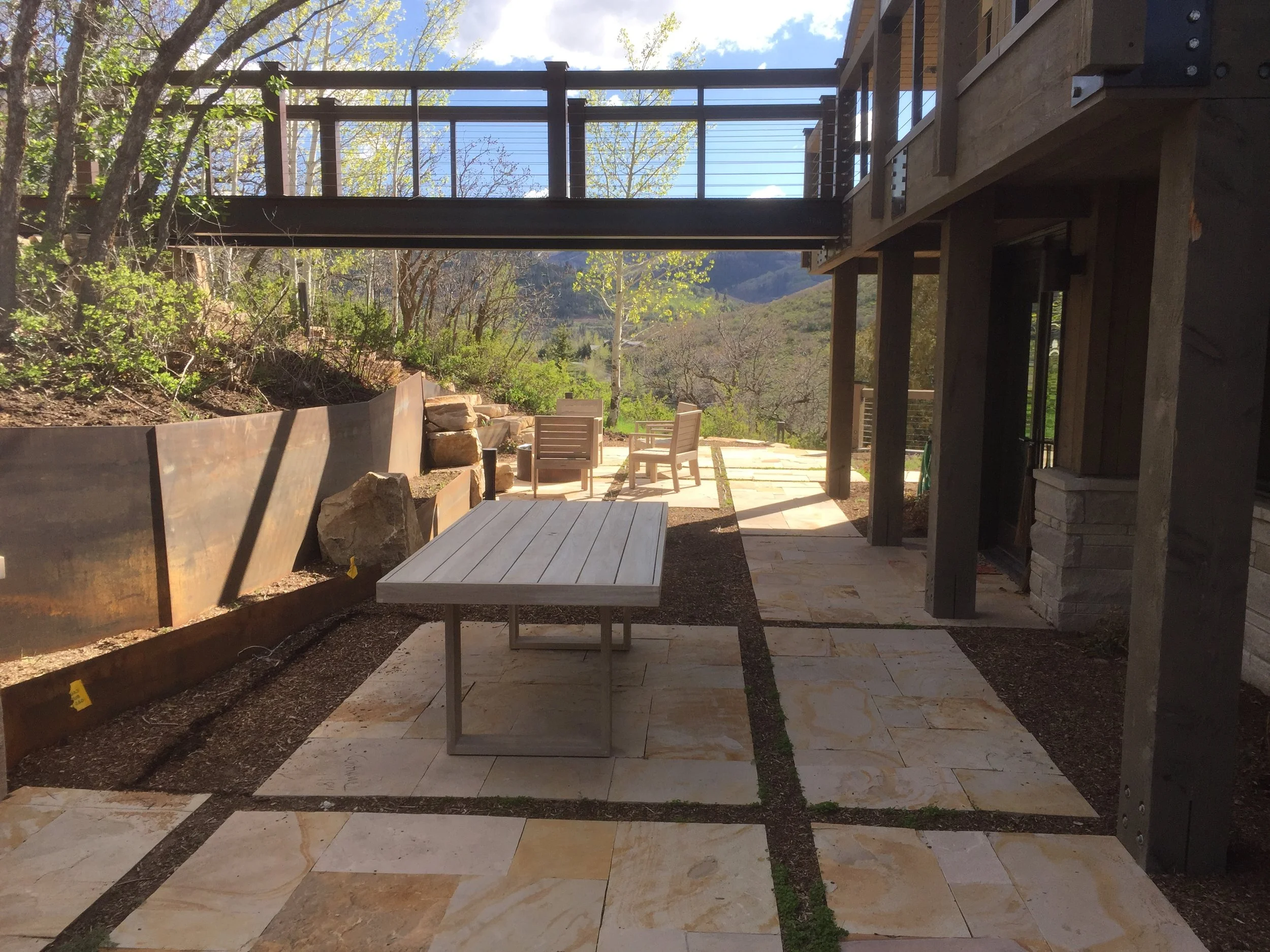 Modern Stone Patio with Metal Retaining Wall