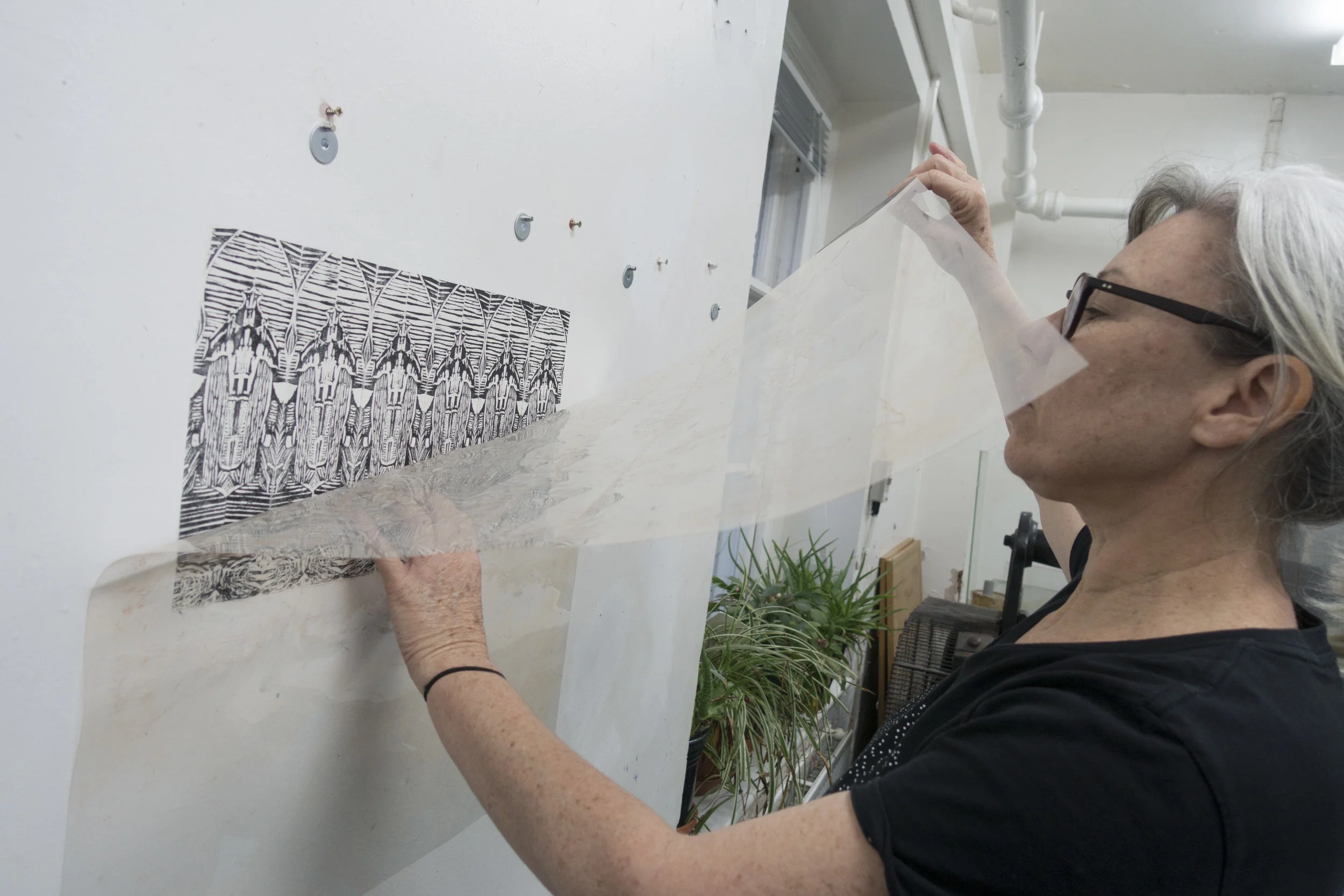 above: Catherine Tempest artist installing work onto the gallery wall - Catherine's work will be a 'paste up' yet to be installed into Gallery 139