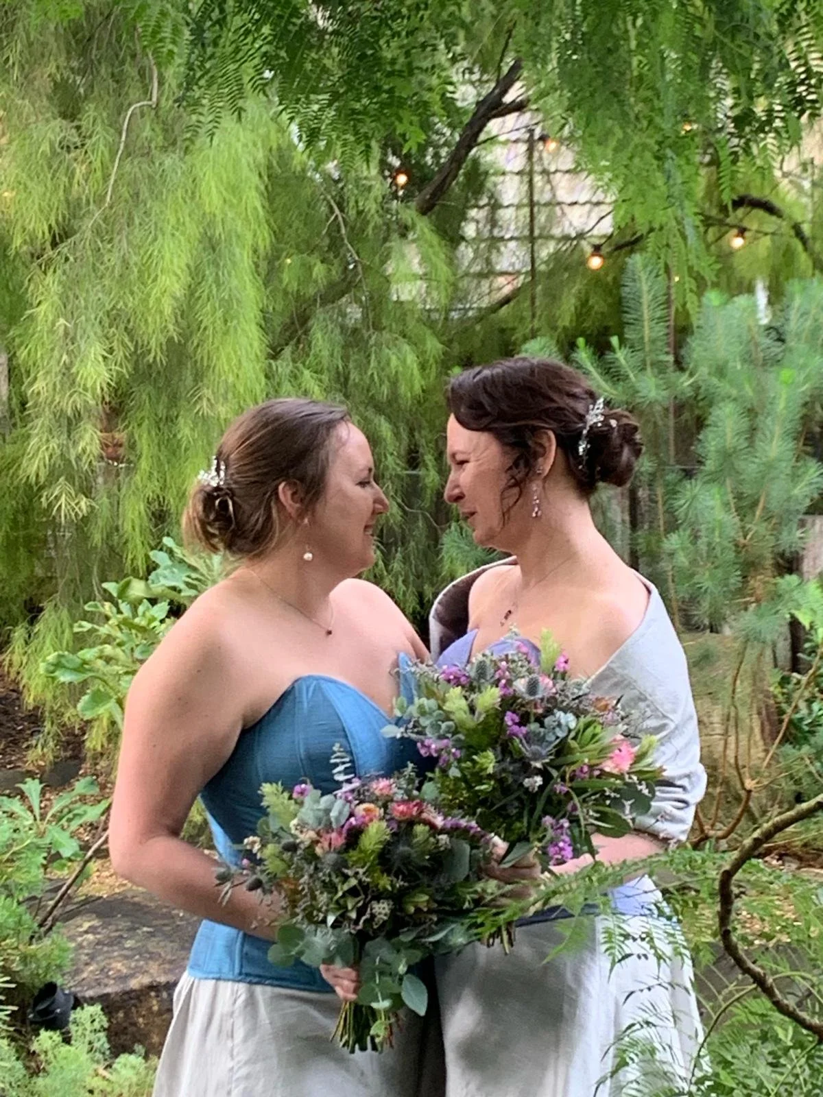two brides in complementary corsets make their vows
