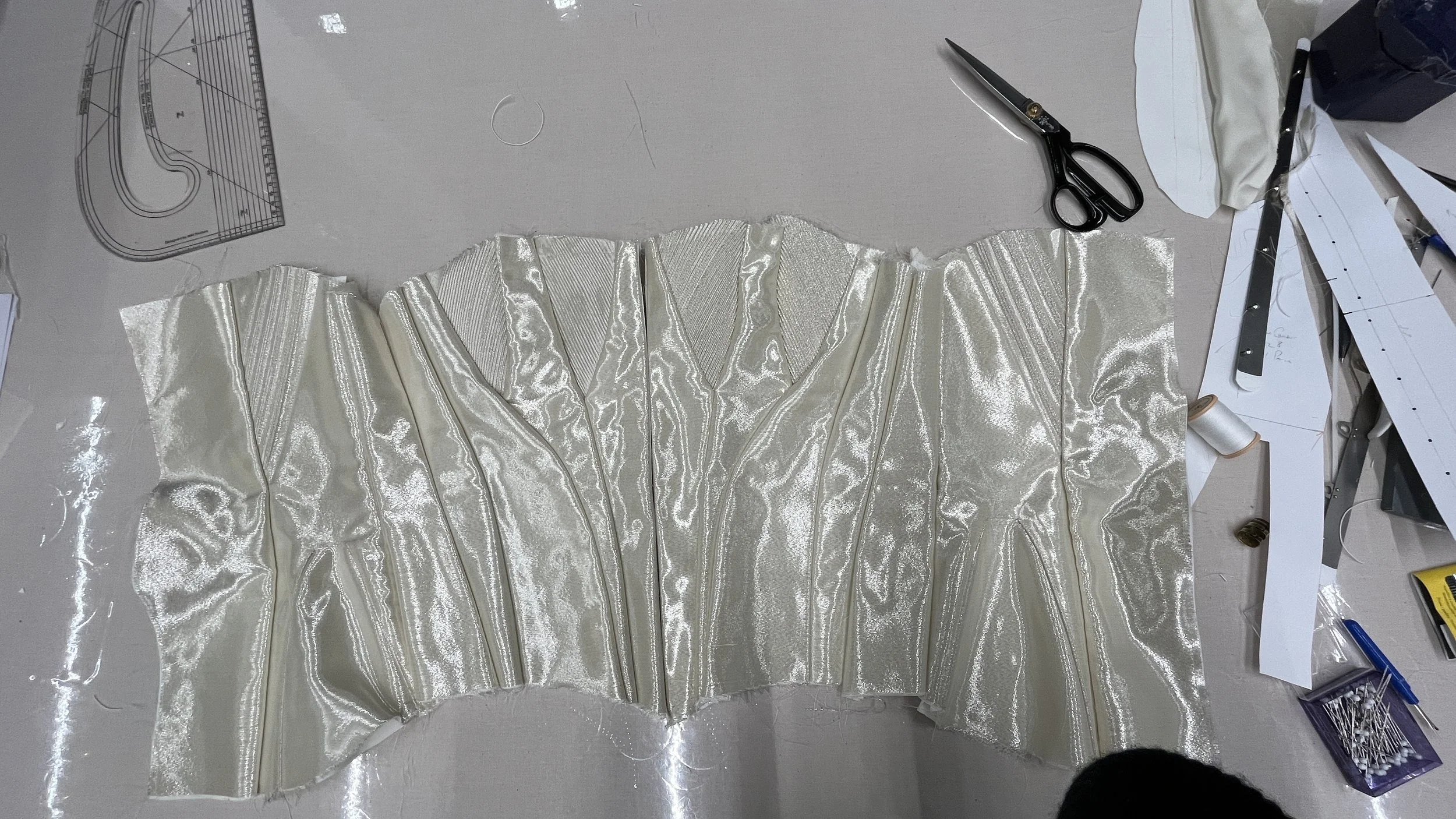 a corset being made in the production studio of Wuthering Heights, gold lame with cording, Edwardian style seams