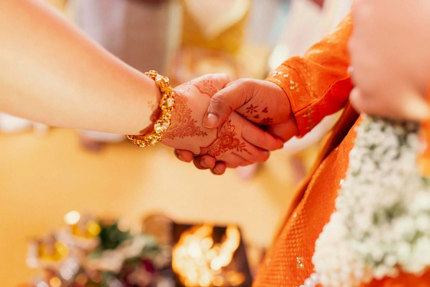 Close up of hands of bride and groom holding each other during pheras