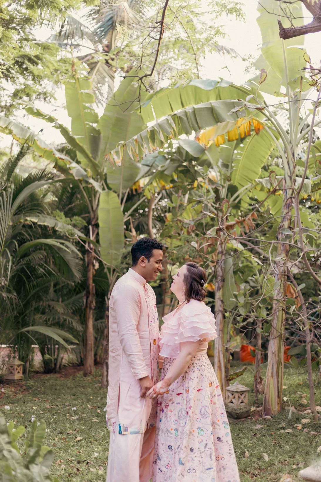 Pre Wedding  PHoto of a couple in a lush green background and they hold each other