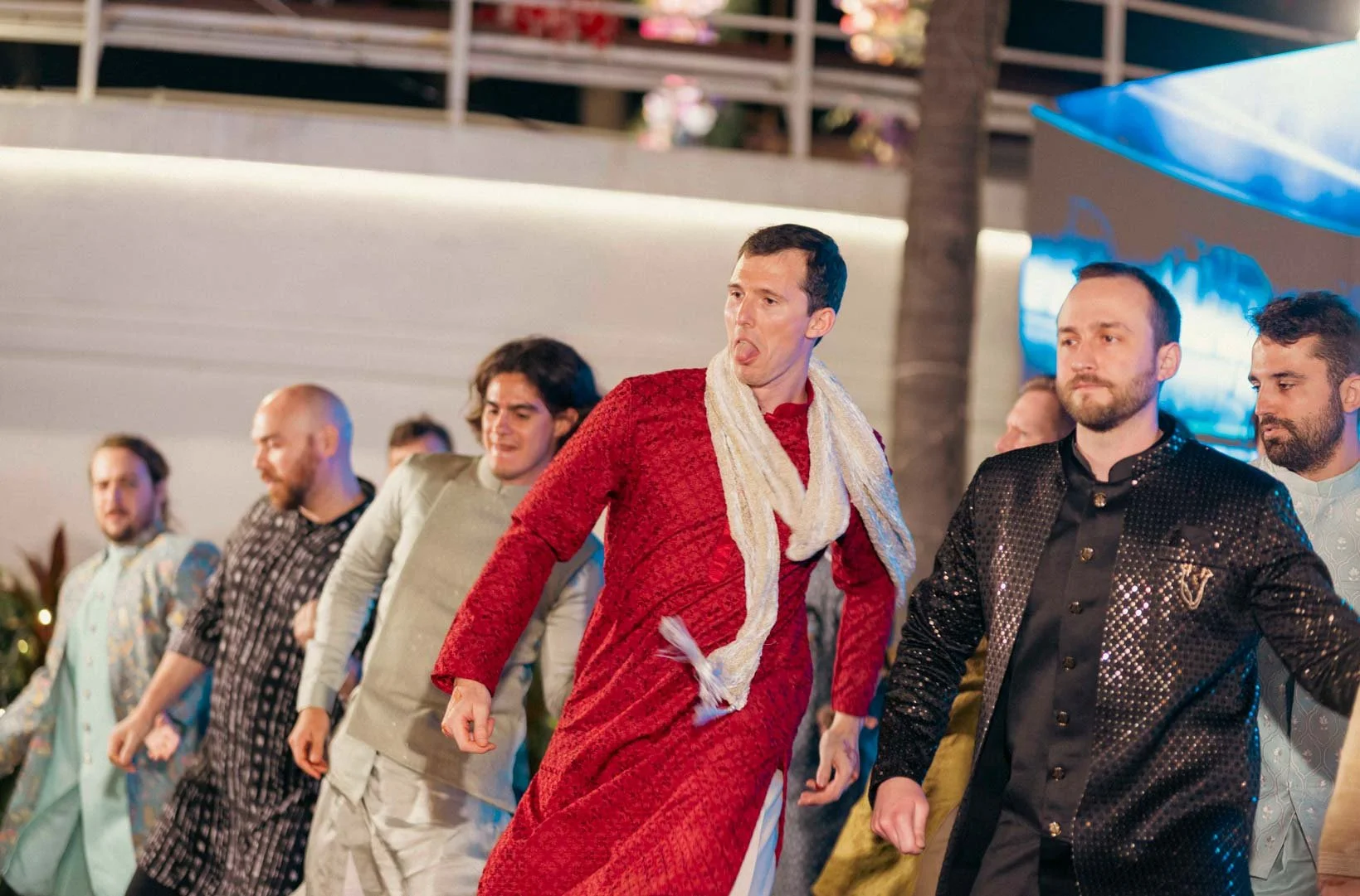 Sangeeth picture of men in a group dance in their most expressive moment