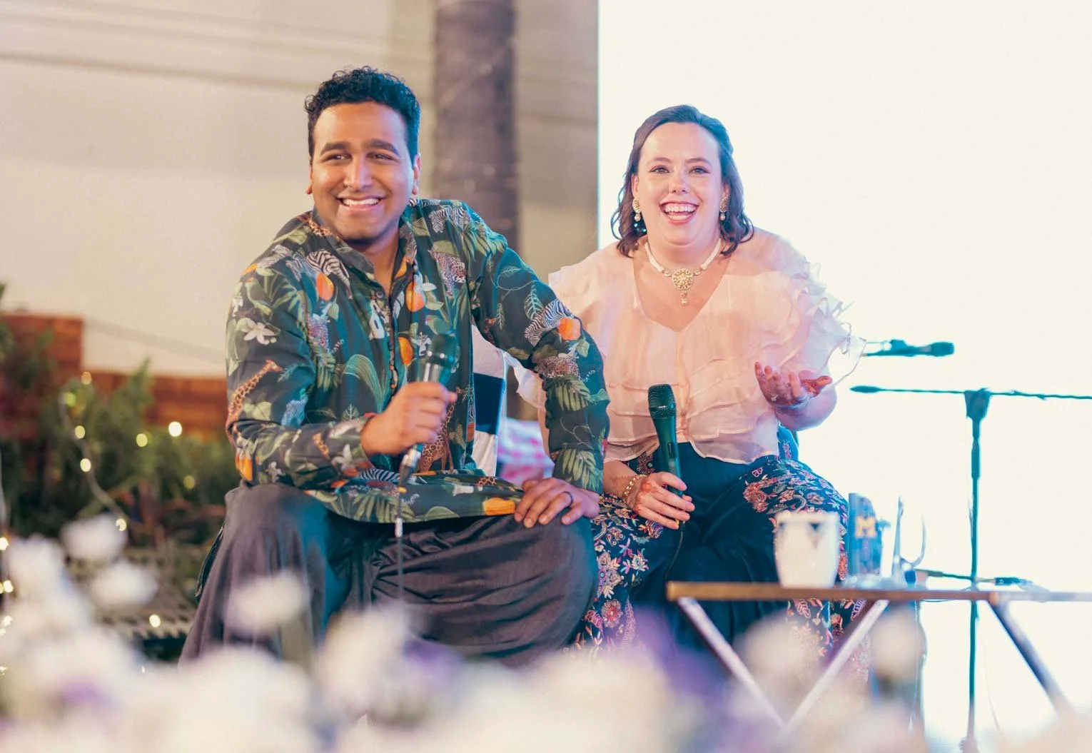 Candid moment as bride and groom interact with the audience for a fun game during their sangeeth and cocktail party