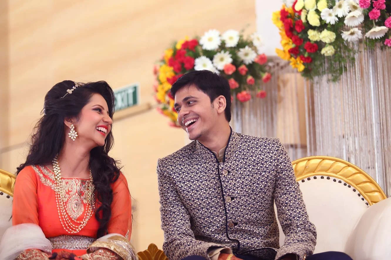 Bride and groom look a each other and smile in a candid moment photo