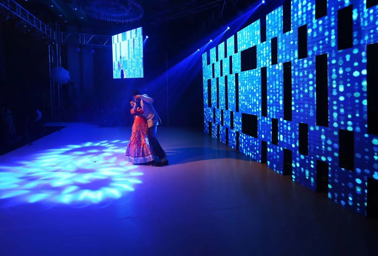 Couple pose during their Sangeeth dance with spolight on them