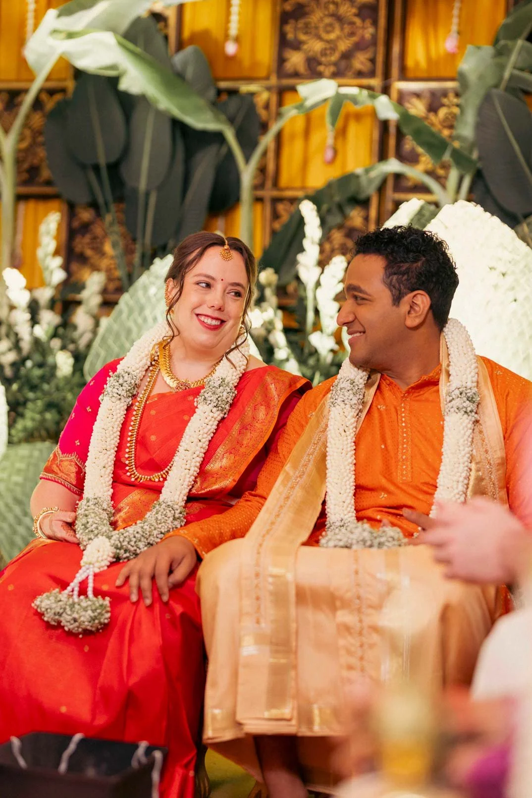 Bride and groom exchange a smile during their south indian wedding rituals
