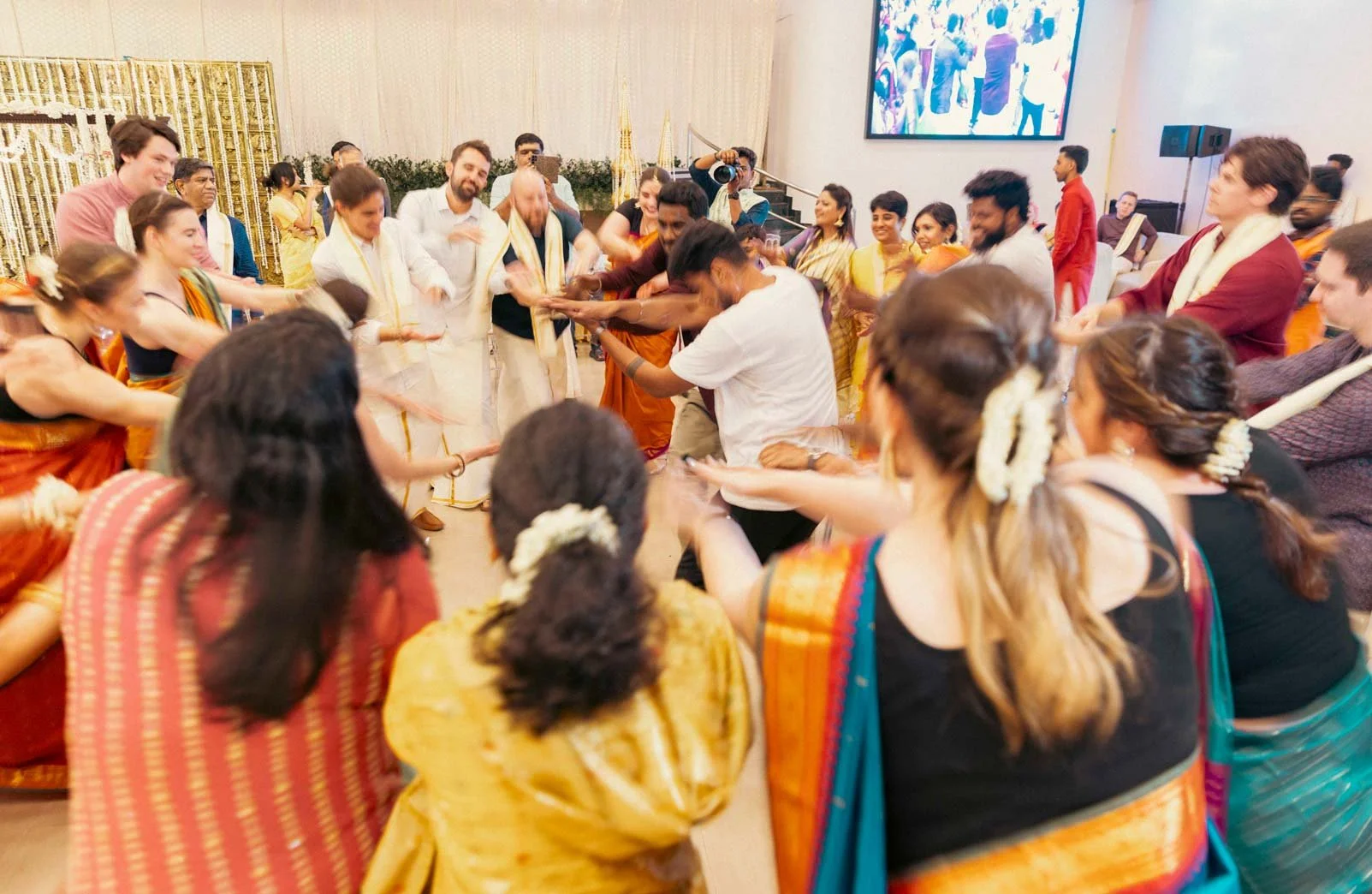 Bridesmaids and NRI guests dance to Indian Music  during South Indian Wedding
