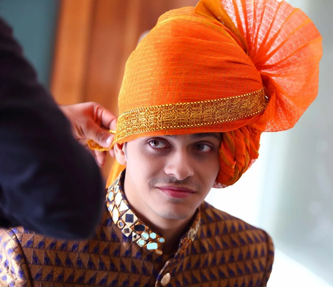 Groom wearing saffron head turban 