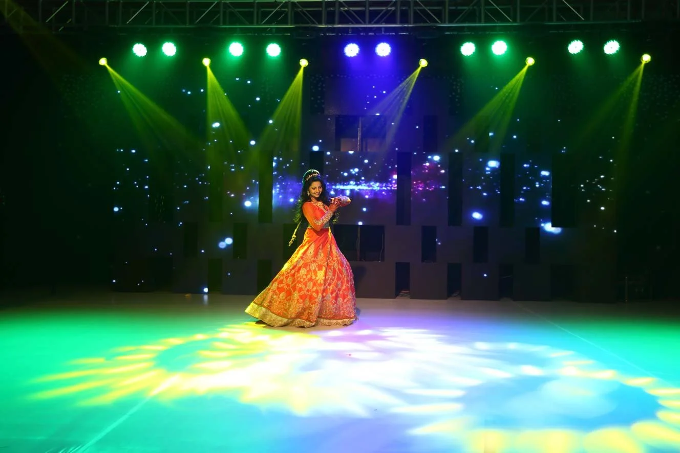 A moment in bride's dance with spotlights on her