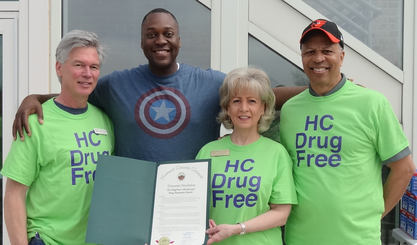 Dr. Calvin Ball (2nd from left) presented HC DrugFree's Executive Director Joan Webb Scornaienchi with a County Council Resolution. Event t-shirt sponsor Dr. Brian Morrison (far left) and Lt. Governor Boyd Rutherford.