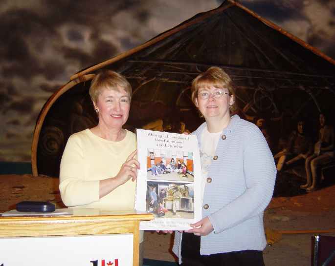 Catherine Power of HSA presents Aboriginal poster series to Brenda Cornick of St. Theresa's Elementary, Port au Choix.