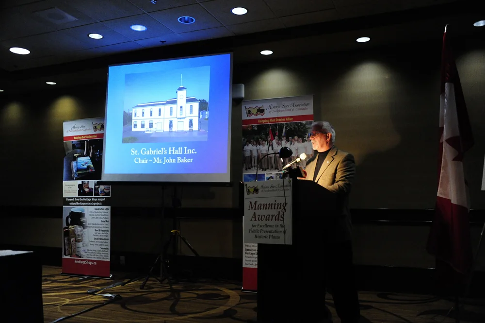 Chair John Baker accepts the award on behalf of St. Gabriel's Hall Inc.