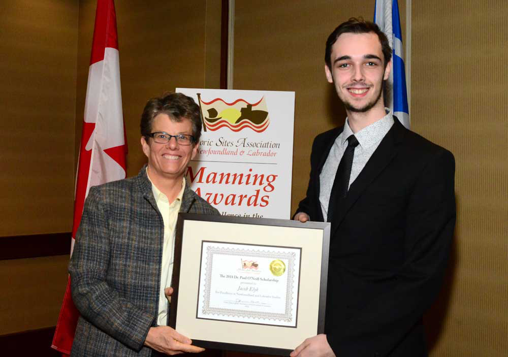 Jacob Elyk is presented with the 2018 Dr. Paul O'Neill Scholarship by Dr. Jennifer Simpson, Dean of Humantities and Social Sciences at Memorial University. 