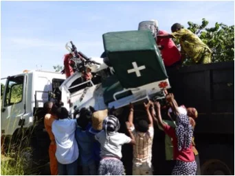 Guludo and Nema staff unloading the ambulances.
