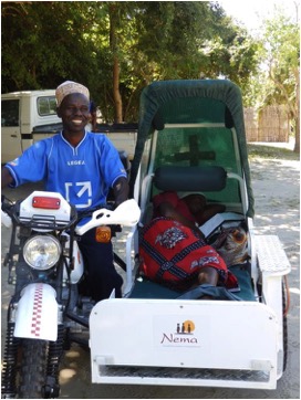 Assane testing out the ambulance with a passenger
