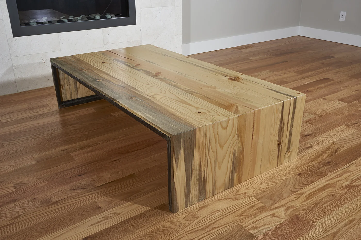 We remodeled our home and had a specific vision for the type of look we wanted. Our living room needed a coffee table. I looked around but had a hard time finding peices in the right dimensions. Our room is long and narrow and I needed a large table. I found Colin through googling around for local artists. He was fast to get in touch with me and enthusiastic about the project. His energy was refreshing in the midst of remodeling and dealing with a lot of trades people who are quite aloof and made me feel like a bother. We met at his studio and chatted about the overall vision for the piece and the colors and textures involved as well as the style we were going for. He was quick to pick up the vibe and soon had a sketch of the table. We talked about slabs and wood grain patterns and colors and came to a quick mutual understanding of what the table would look like. He was swamped with work but still finished the table and delivered it to our home on time and again, without making me feel like a bother. We had an issue with the wood a few months after the table was delivered and Colin was quick to resolve the matter. In addition to our coffee table, Colin designed and built a tv console for our newly renovated bedroom. Aside from cost and dimensions, Colin had creative license to create the piece. He had a good understanding of our style and function needs and he nailed it. We love it! He's a true artist and professional. The world could use more Colins!