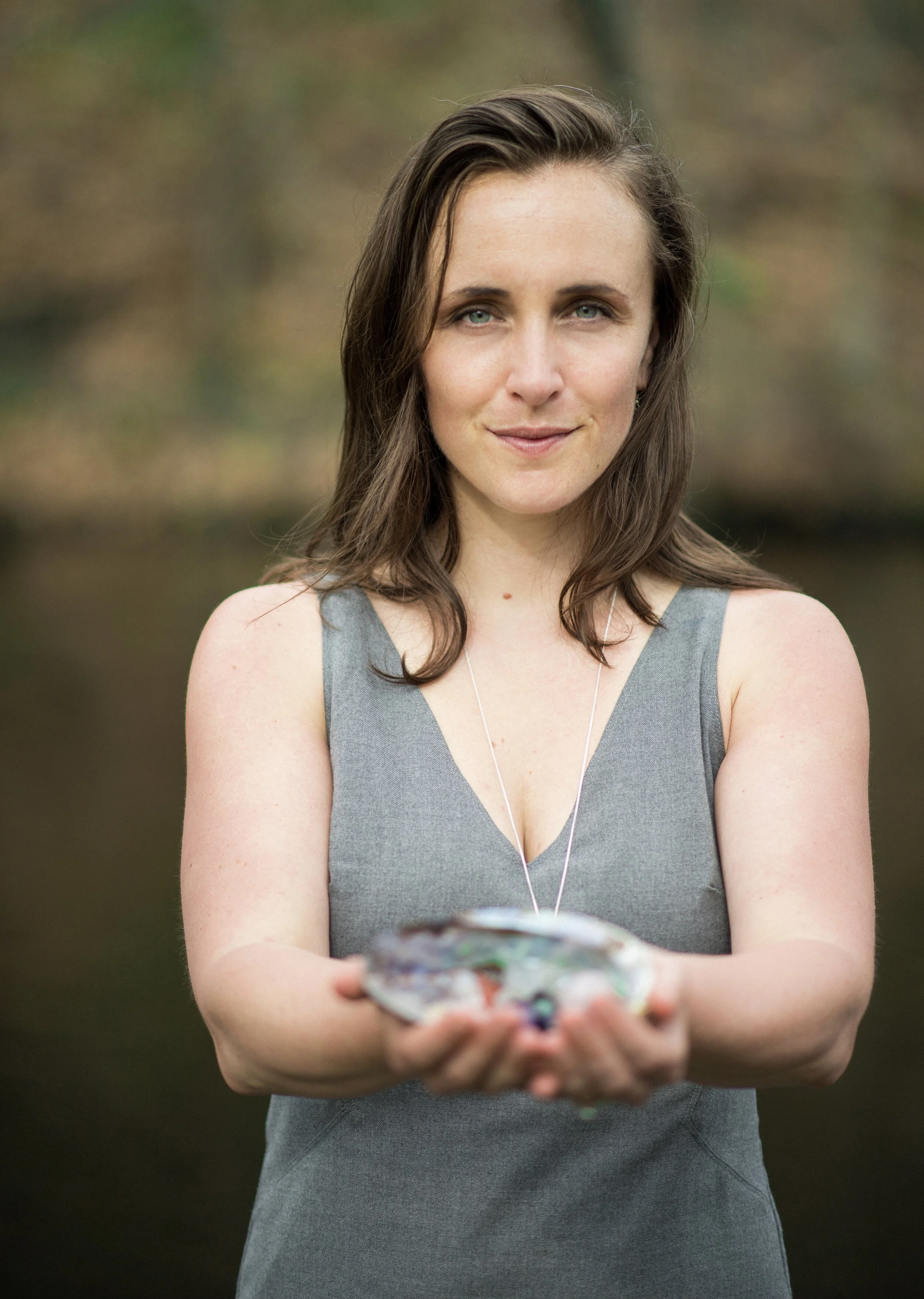 Image of a woman holding healing crystals and supporting deep transformation of the soul