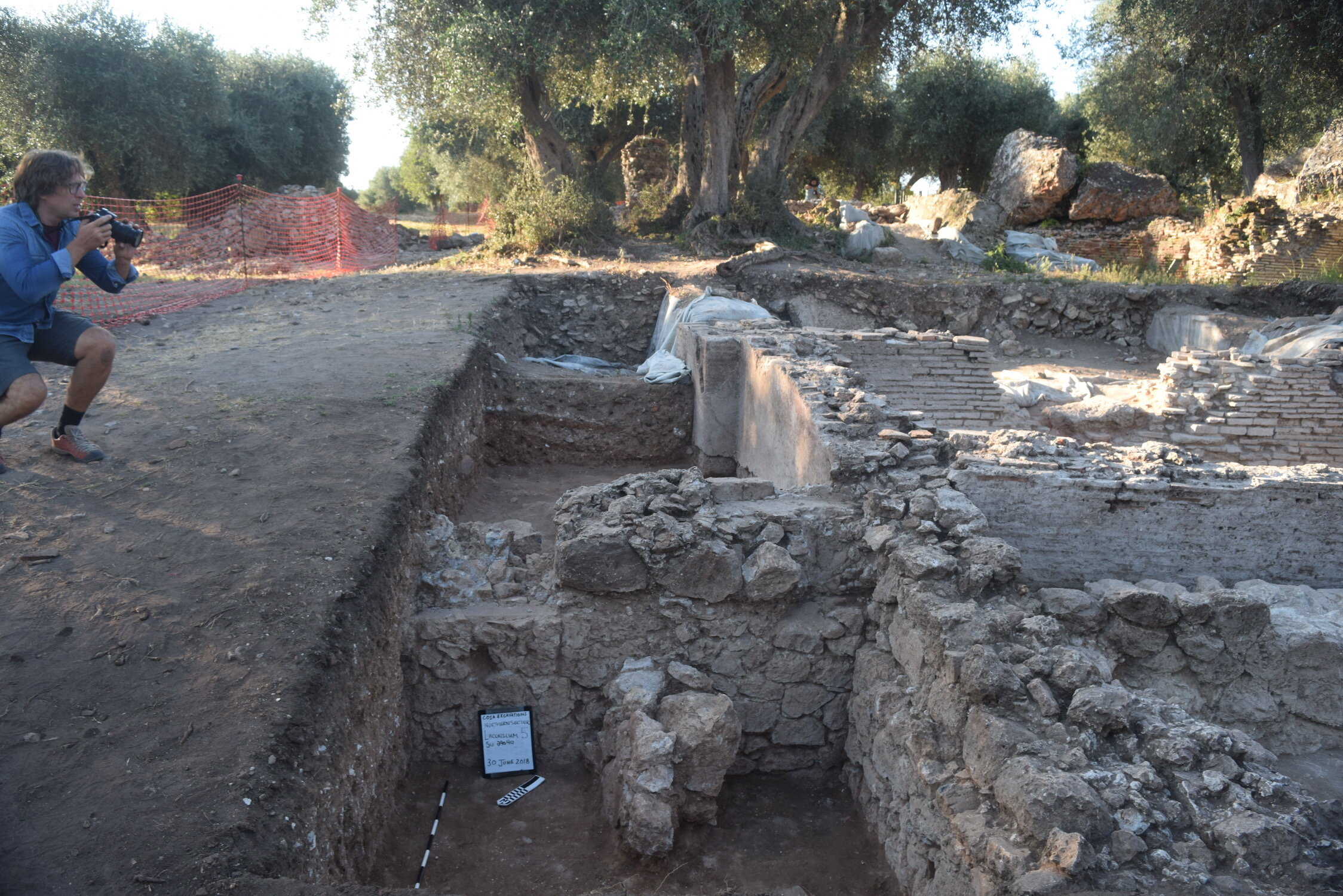 Dr. Andrea De Giorgi photographs the northeastern area of the bath complex after the 2018 excavation season. 