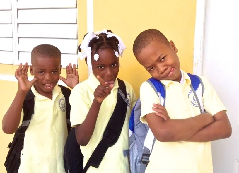 T12 students Christ Capable, Wichnida, Isaac posing for a funny photo before school. 