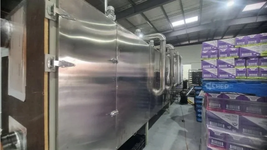 Commercial conveyor belt dryer used by Carnivore Pet Kitchen for gummy production.