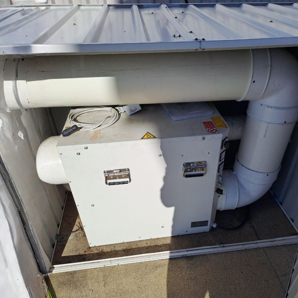 Commercial dehumidifier installed in a restricted space with limited access for maintenance and servicing.