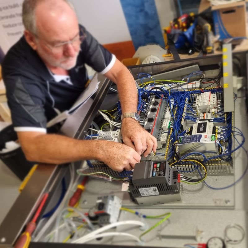 Industrial dehumidifier technician performing electrical diagnostics and repair on control panel