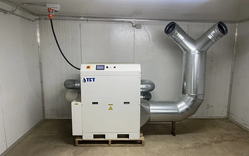 AD 2500 desiccant dehumidifier with heat recovery ductwork installed in the drying room