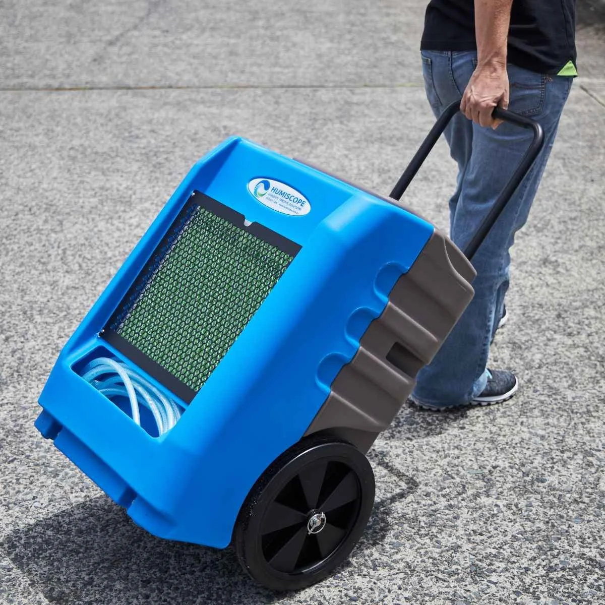Commercial portable dehumidifier being moved for moisture control