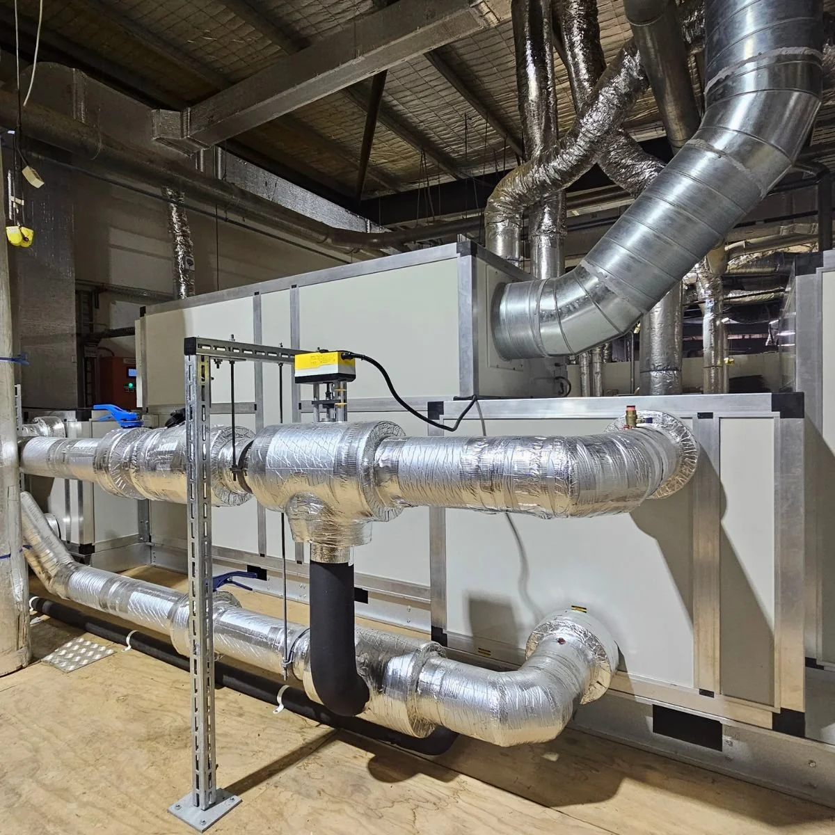 Ducted industrial dehumidifier installation with connected supply and return ductwork.