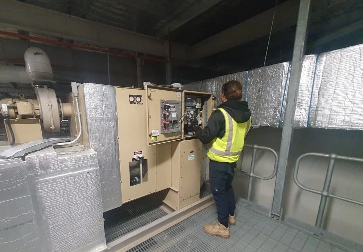 Dehumidifier service technician inspecting and maintaining industrial humidity control system