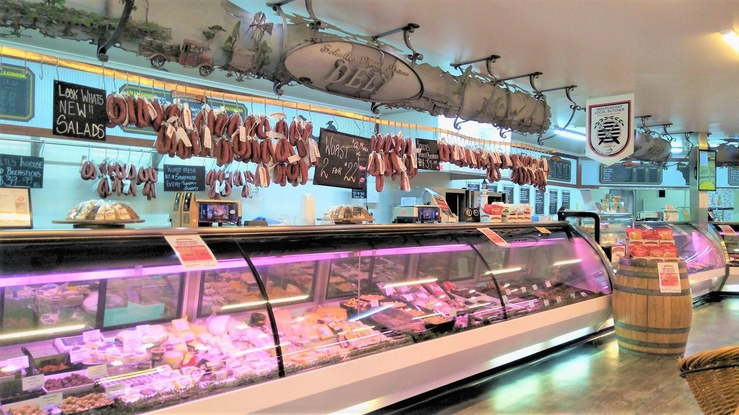 Interior of Schulte’s gourmet butcher and delicatessen in Queensland with sausages hanging above the meat counter