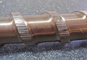 Extreme wear on these screw flights was caused by binding due to a difference in coefficient of thermal expansion between the barrel and screw.