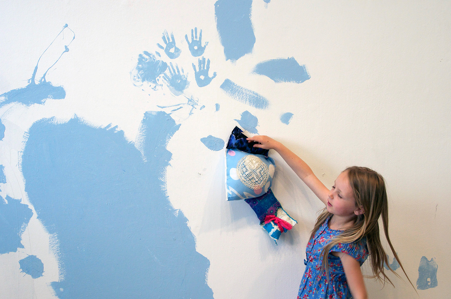 She stuffed the shapes and had me glue gun them closed. Then she artfully attached them to the wall.