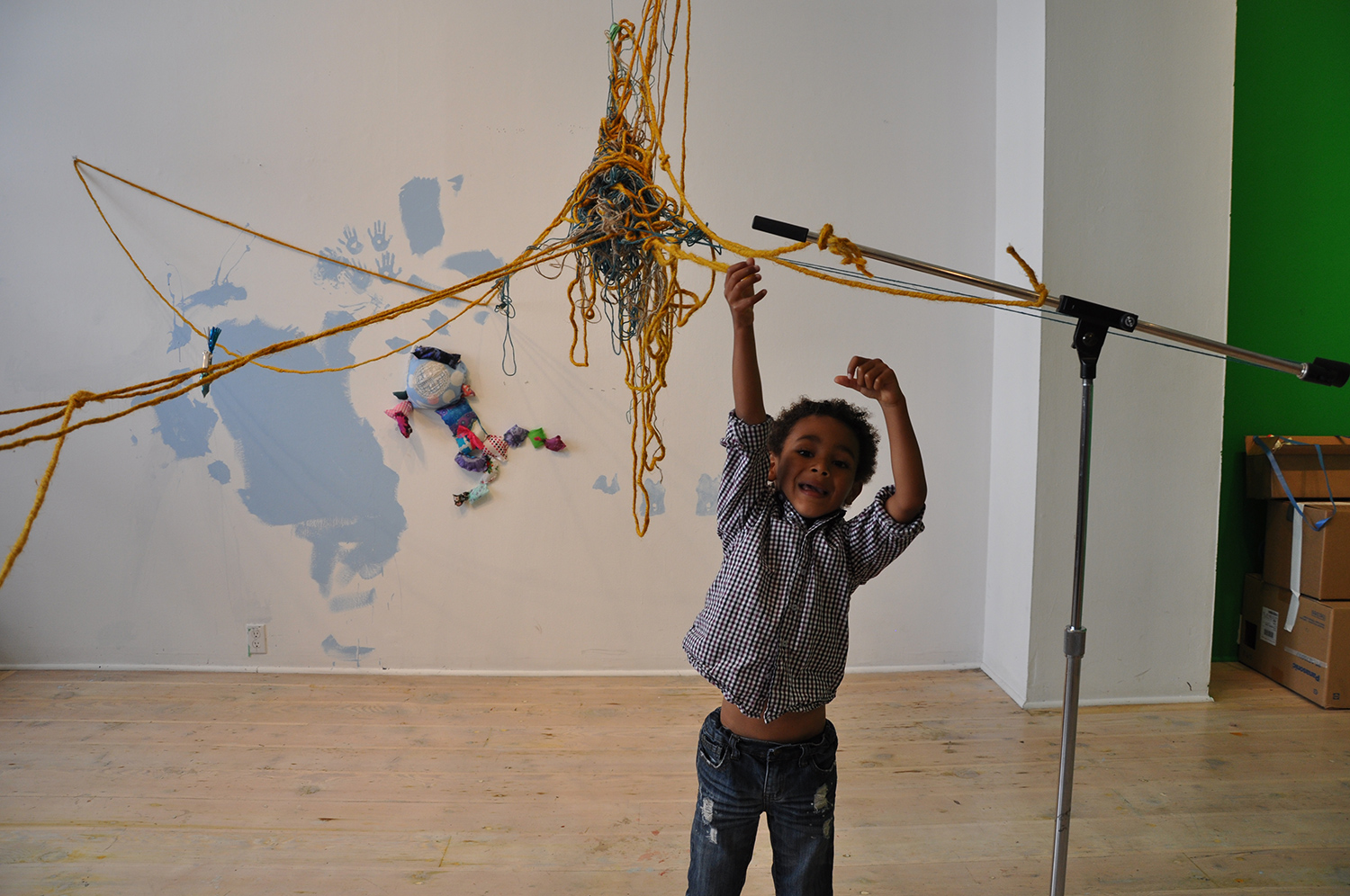 It involved balls and balls of string and yarn, some things like mic and music stands, a chair, and a short ladder. Then for 3 hours he hurdled these balls of materials back and forth to form his laser net.
